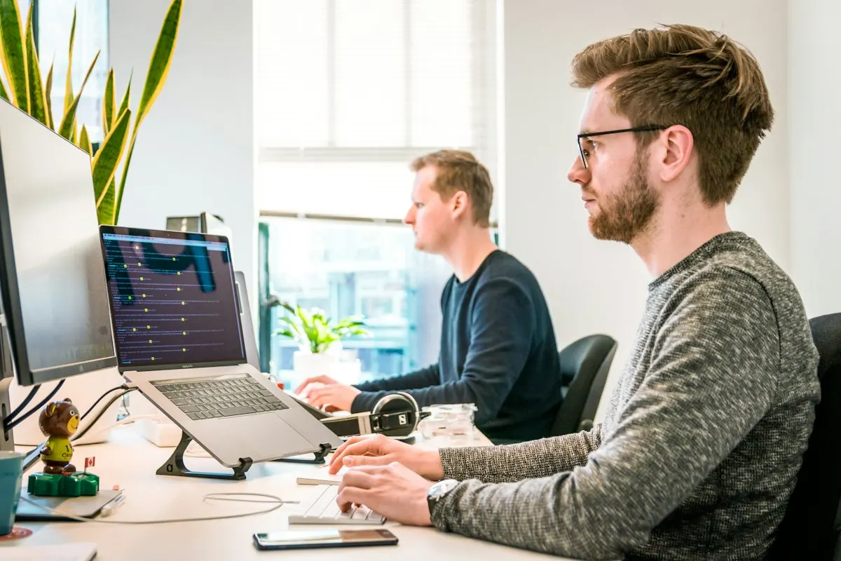 A developer writing code at a desk