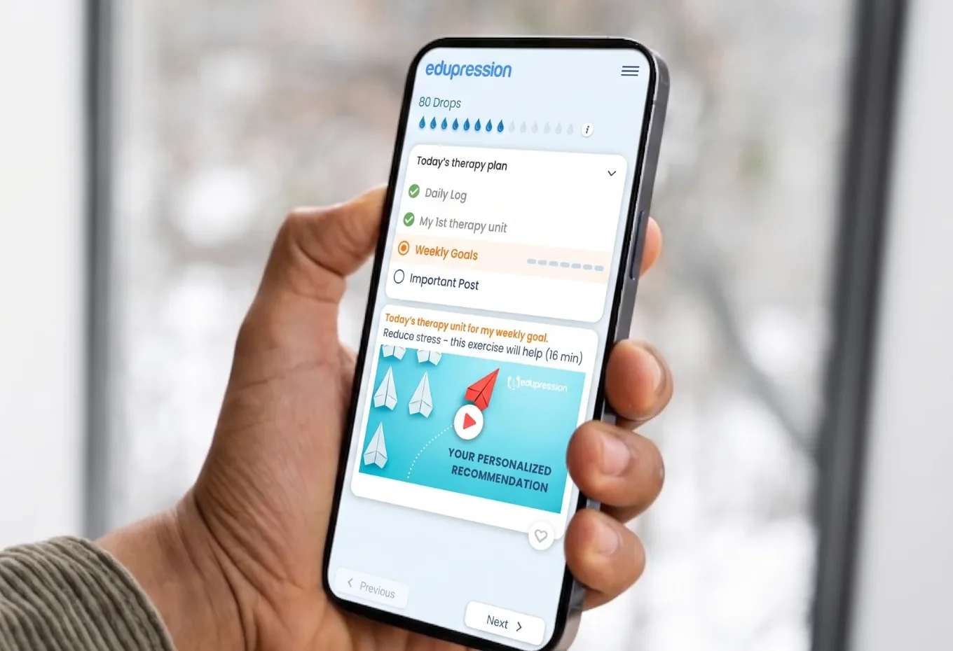 A patient holding a phone with Edupression open on today's therapy plan and weekly goals